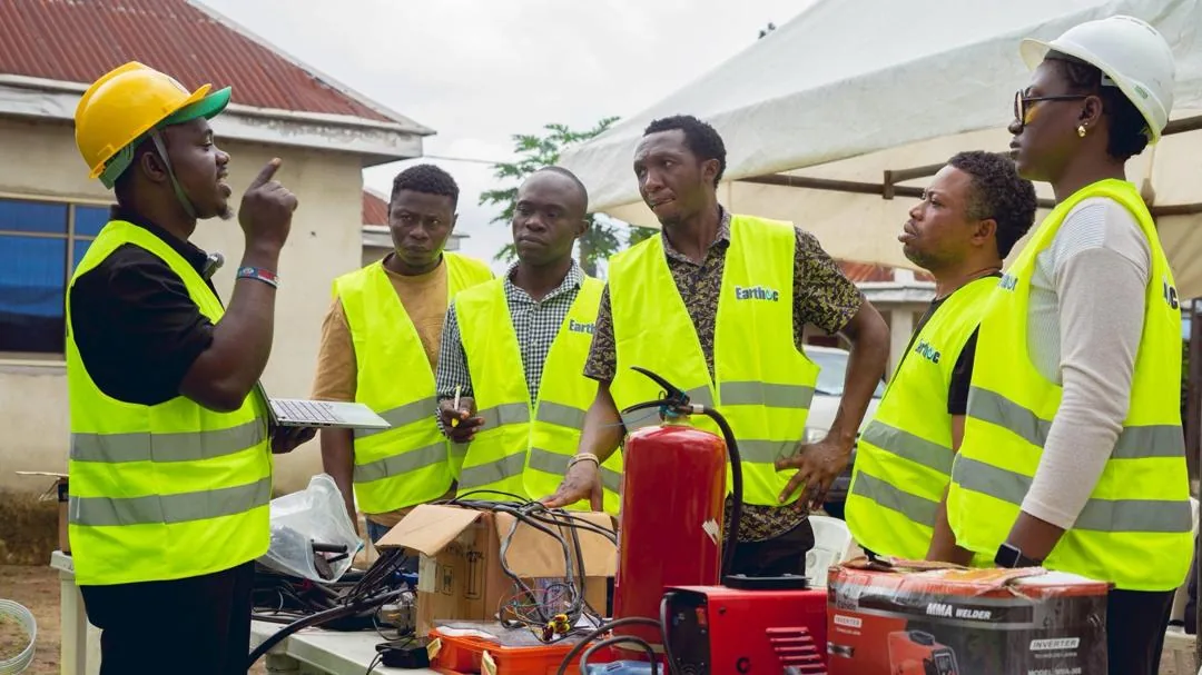 An Earthoc instructor briefing trainees around technical equipment